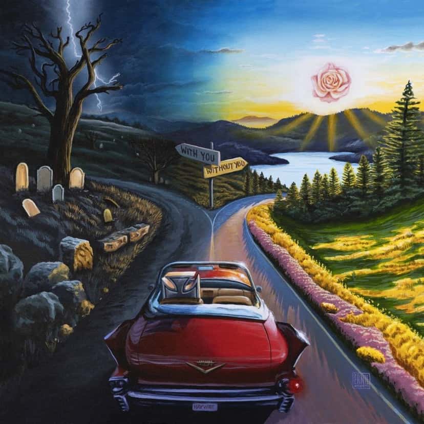 Portada de «I Don't Wanna Say Goodbye», de Haywire: un Cadillac rojo en una ruta que se divide entre un lado oscuro con tumbas y otro soleado con flores, bajo un cartel que dice «With you» y «Without you»