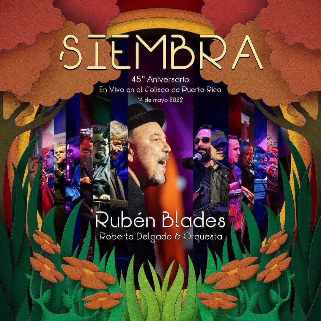 Portada de «Siembra: 45° Aniversario», de Rubén Blades con Roberto Delgado y Orquesta: el cantante y la orquesta sobre un escenario iluminado, enmarcados por plantas y flores naranjas ilustradas
