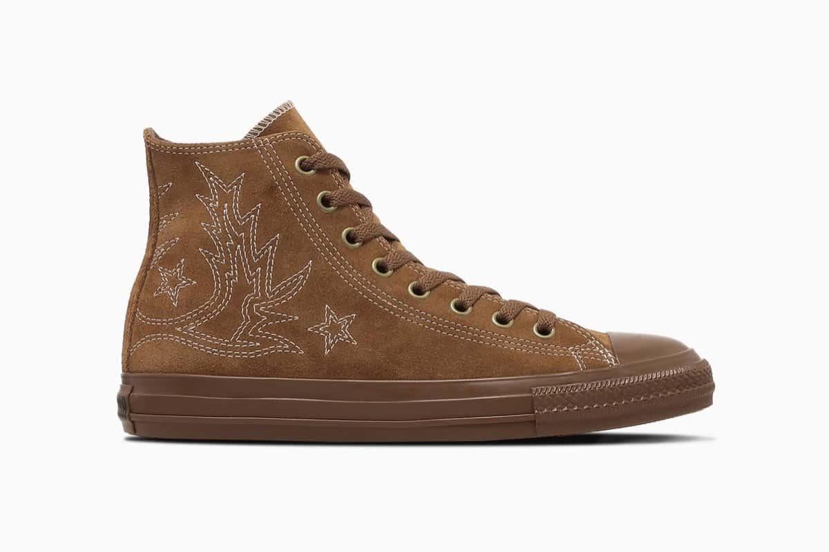 Converse All Star Westernstitch SU HI en color tan de perfil sobre fondo blanco, con caña alta de gamuza marrón, pespuntes claros con dibujo de bota vaquera y dos estrellas en el costado, ojalillos dorados, cordones marrones y suela de goma del mismo tono que la capellada