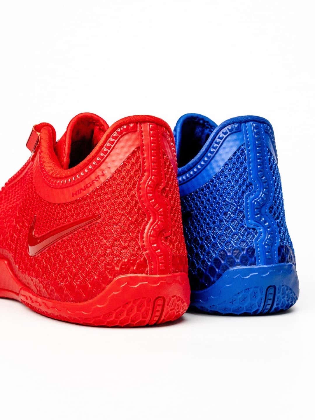 Talones de la Nike LeBron 24 Philly, una roja y una azul, con la suela del mismo color que la capellada