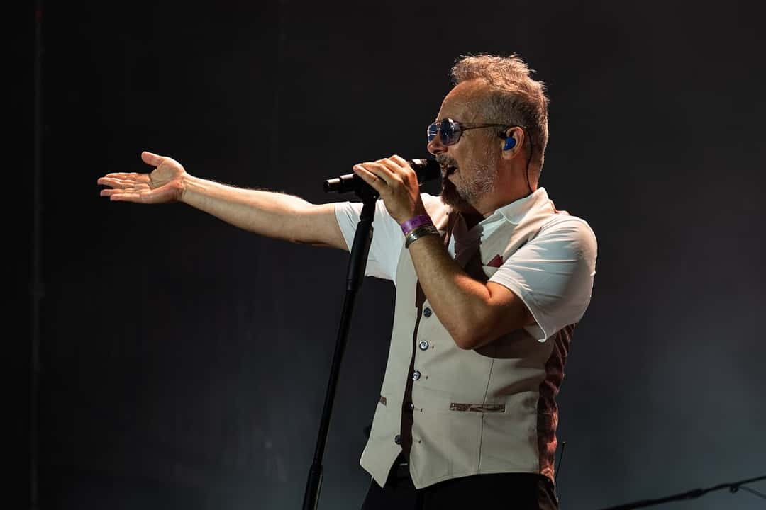 Santi Balmes, cantante de Love of Lesbian, canta con anteojos oscuros y chaleco blanco, con un brazo extendido hacia el público, en el Brisa Festival (foto de archivo, julio de 2026). Foto: Pedro J Pacheco, CC BY-SA 4.0, vía Wikimedia Commons