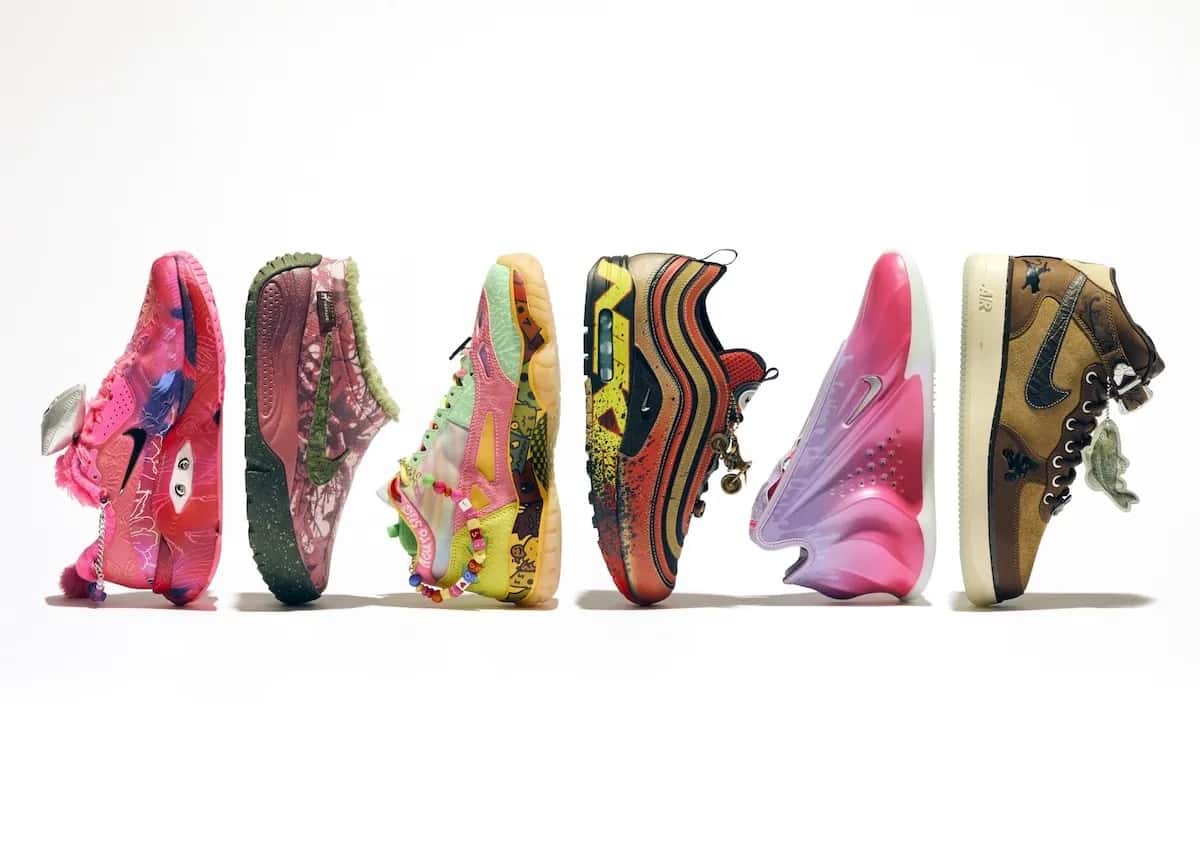 Los seis pares de la colección Nike Doernbecher Freestyle 22 en fila sobre fondo blanco, cada uno con colores, dibujos y colgantes propios: uno rosa con ojos, uno verde y bordó, uno verde agua y rosa, un Air Max 1/97 rojo y dorado, uno rosa y lila, y un Air Force 1 Mid marrón
