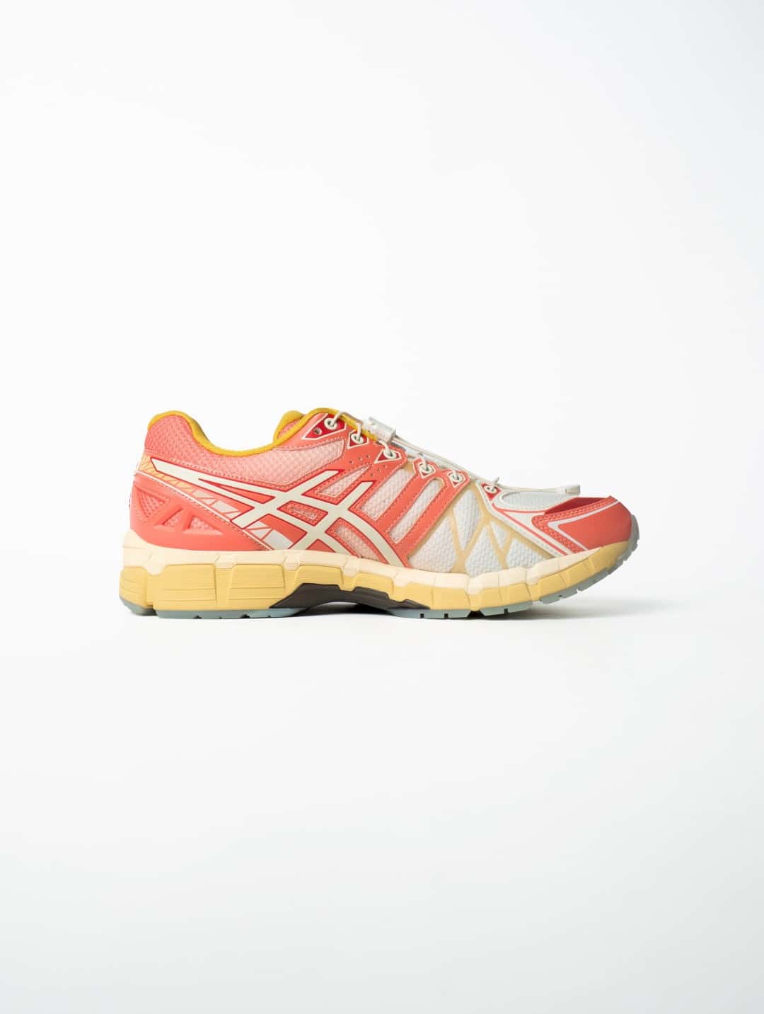 SneakerLAH x ASICS GEL-KAYANO 20 Ice Kacang de perfil sobre fondo blanco, con upper blanco y coral, logo de ASICS en tono crema, cuello amarillo, cordones con traba y mediasuela amarilla y crema